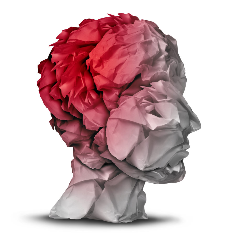Head injury and traumatic brain accident medical and mental health care concept with a group of crumpled office paper shaped as a human mind with red highlighted area as a symbol of trauma problem.